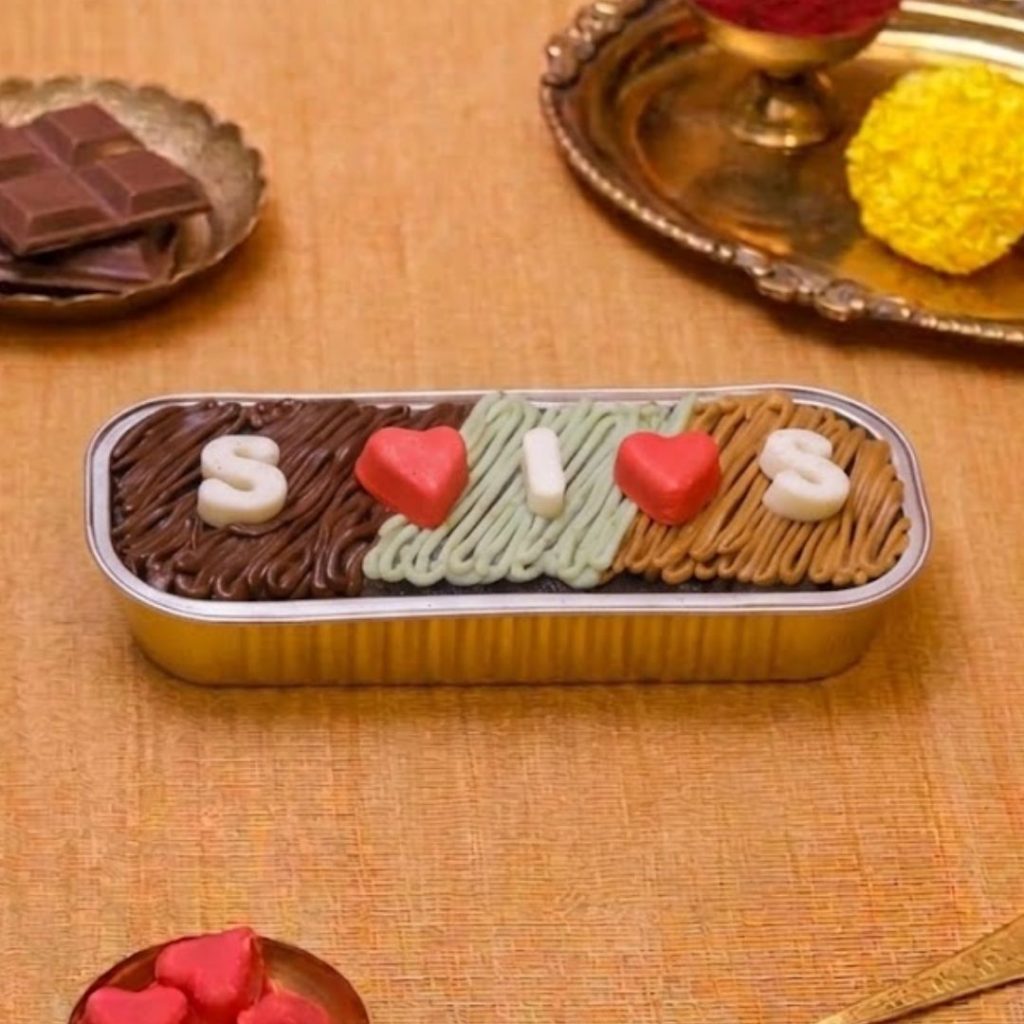 Sis Love Raksha Bandhan Cake, a unique Rakhi cake design for sister with chocolate ganache and pencil-box packaging